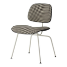 The Upholstered Eames Molded Plastic Dining Chair from Herman Miller with black and white checker upholstery, black shell and white leg finish.