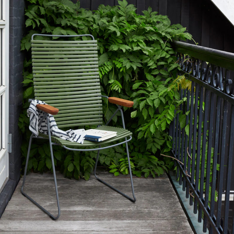 The Click Outdoor Position Chair by Houe in the balcony with plants.