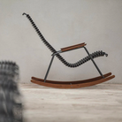The Click Outdoor Rocking Chair by Houe is in the studio from a side angle.