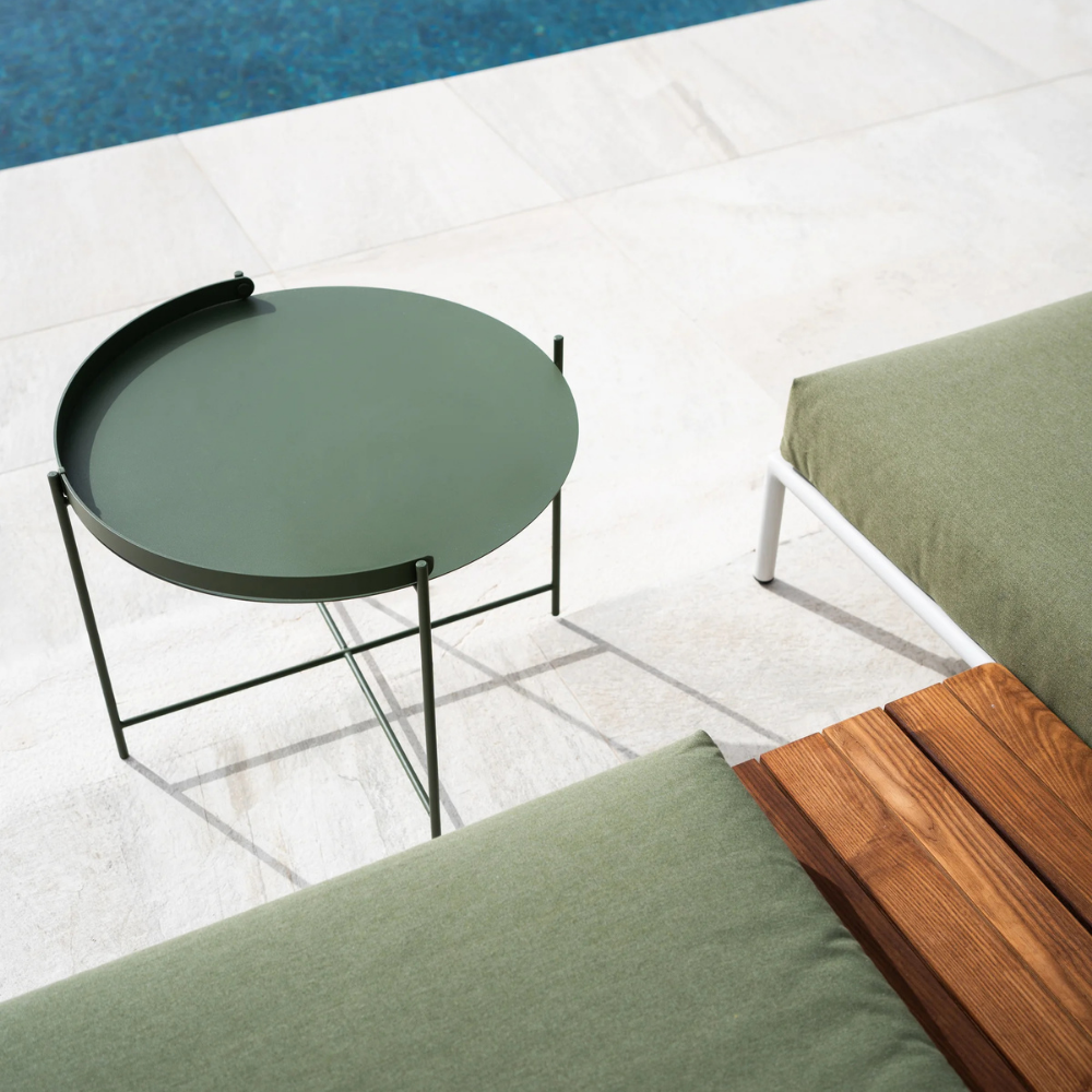 The Edge Tray Coffee Table, Medium in Olive Green beside a pool.