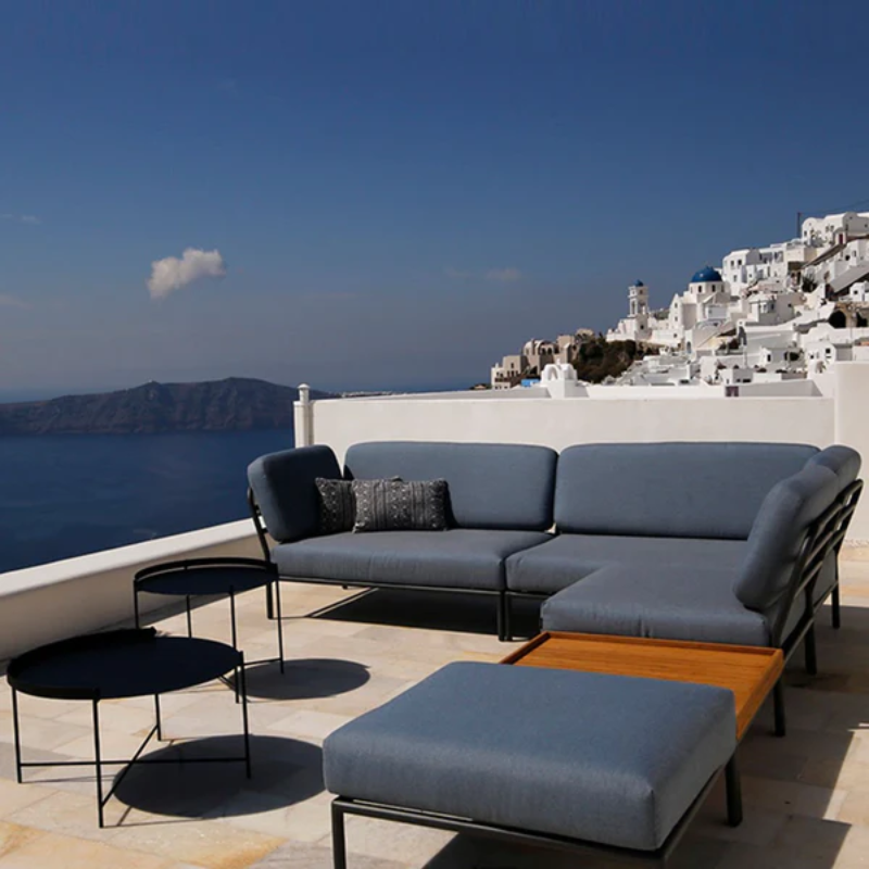 The Edge Outdoor Tray Coffee Table by Houe on a rooftop terrace with an ocean view.