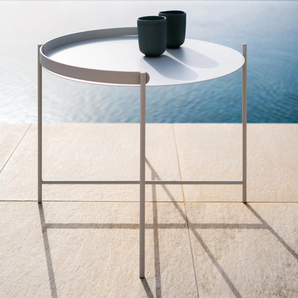 The Edge Tray Coffee Table, Medium in Muted White on a pool deck.