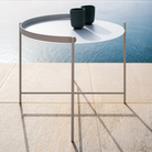 The Edge Tray Coffee Table, Medium in Muted White on a pool deck.