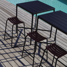 The black Four Outdoor Bar Table Bamboo by Houe with chairs from the poolside.
