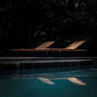 The Molo Sunbed by Houe with contrast at the poolside.