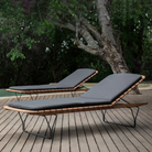 The Molo Sunbed Cushion by Houe with two sunbeds on a wooden deck.