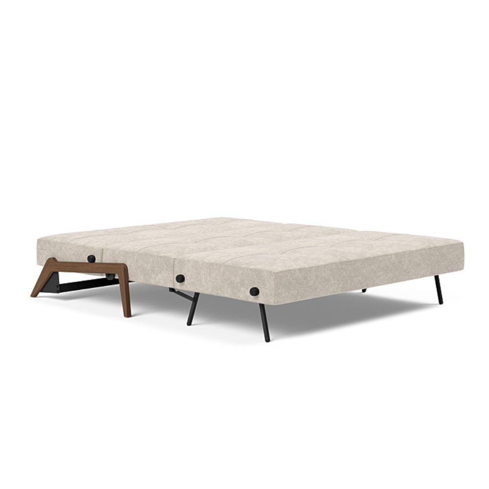The Cubed Queen Size Sleeper Sofa with Wood Legs from Innovation Living with dark lacquered oak legs and avella sand 280 upholstery setup as a bed.