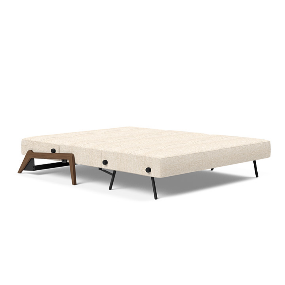 The Cubed Queen Size Sleeper Sofa with Wood Legs from Innovation Living with dark lacquered oak legs and halifax shell 365 upholstery setup as a bed.