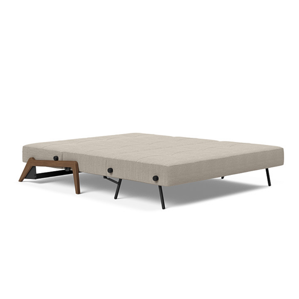 The Cubed Queen Size Sleeper Sofa with Wood Legs from Innovation Living with dark lacquered oak legs and kenya gravel 579 upholstery setup as a bed.