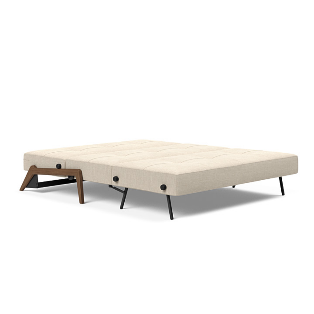 The Cubed Queen Size Sleeper Sofa with Wood Legs from Innovation Living with dark lacquered oak legs and phobos latte 588 upholstery setup as a bed.