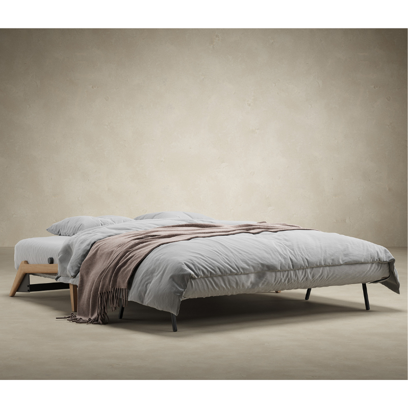 The Cubed Queen Size Sleeper Sofa with Wood Legs from Innovation Living with lacquered oak legs set up as a bed. all-groups