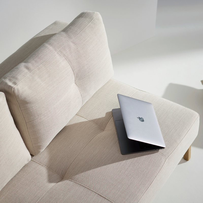 The Cubed Queen Size Sleeper Sofa with Wood Legs from Innovation Living with lacquered oak legs and blida sand grey 612 upholstery in a living space.