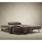 The Cubed Queen Size Sleeper Sofa with Wood Legs from Innovation Living with lacquered oak legs and esina cedar brown 411 upholstery opened into a bed in a family area.
