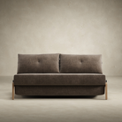 The Cubed Queen Size Sleeper Sofa with Wood Legs from Innovation Living with lacquered oak legs and esina cedar brown 411 upholstery from the front in a studio.