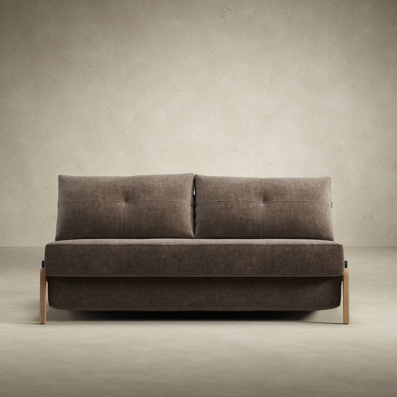The Cubed Queen Size Sleeper Sofa with Wood Legs from Innovation Living with lacquered oak legs and esina cedar brown 411 upholstery from the front in a studio.
