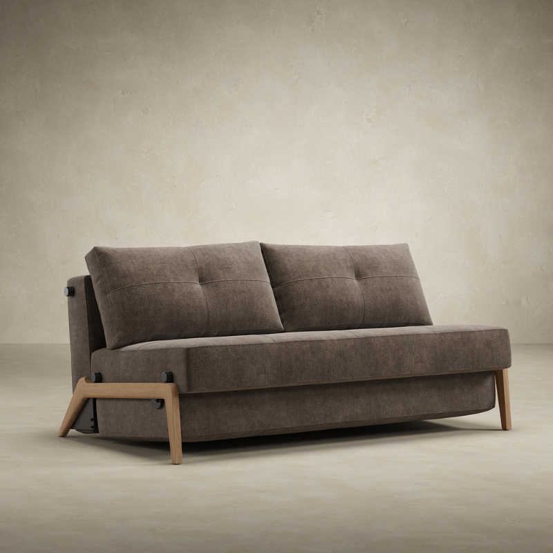 The Cubed Queen Size Sleeper Sofa with Wood Legs from Innovation Living with lacquered oak legs and esina cedar brown 411 upholstery from the side in a living space.