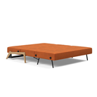 The Cubed Queen Size Sleeper Sofa with Wood Legs from Innovation Living with lacquered oak legs and esina rust orange 412 upholstery setup as a bed.