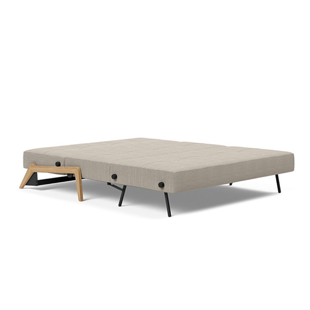 The Cubed Queen Size Sleeper Sofa with Wood Legs from Innovation Living with lacquered oak legs and kenya gravel 579 upholstery setup as a bed.