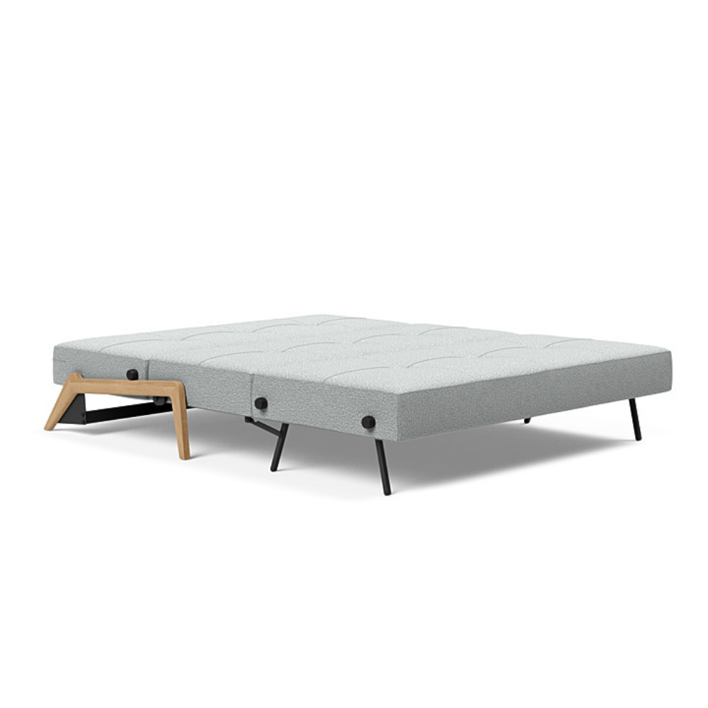 The Cubed Queen Size Sleeper Sofa with Wood Legs from Innovation Living with lacquered oak legs and melange light grey 538 upholstery setup as a bed.
