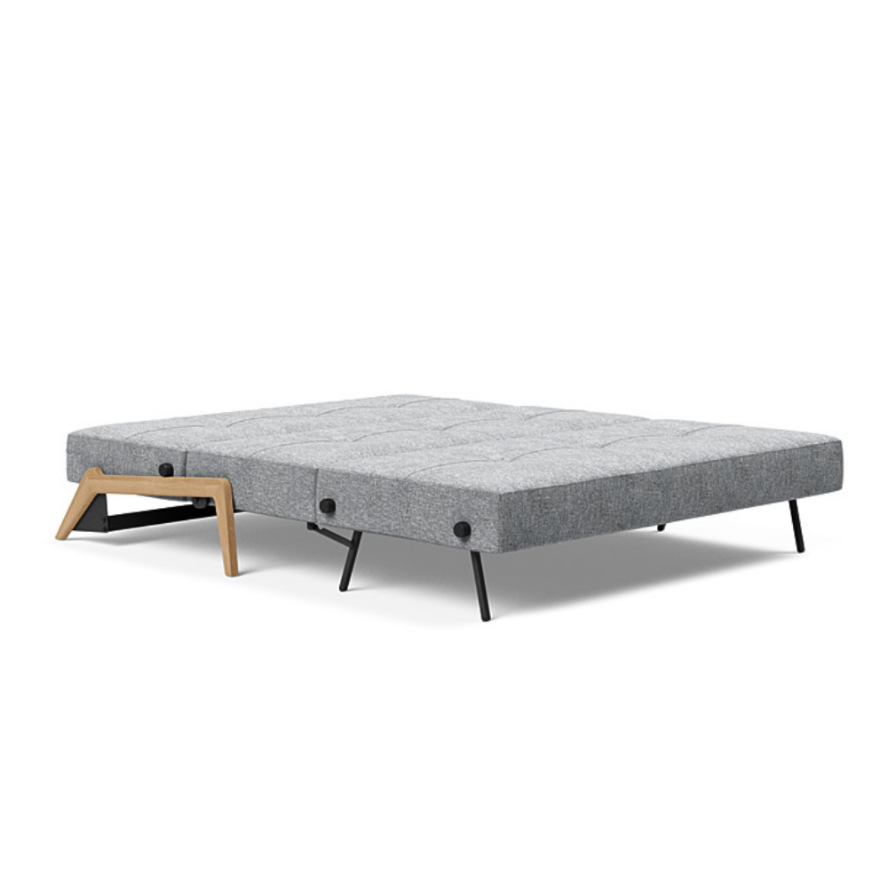 The Cubed Queen Size Sleeper Sofa with Wood Legs from Innovation Living with lacquered oak legs and twist granite 565 upholstery setup as a bed.