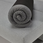 The King Size Mattress Pillow Topper from Innovation Living rolled up on a sofa bed.