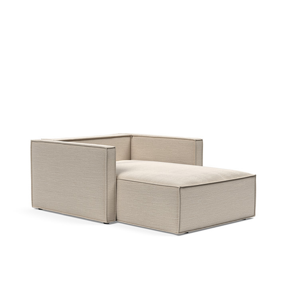 The Newilla Lounger Chair with Slim Arms with blida sand grey 612 upholstery without the cushion, setup as a bed.