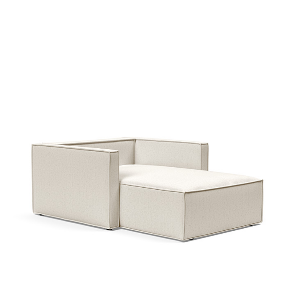 The Newilla Lounger Chair with Slim Arms with boucle off white 531 upholstery without the cushion, setup as a bed.
