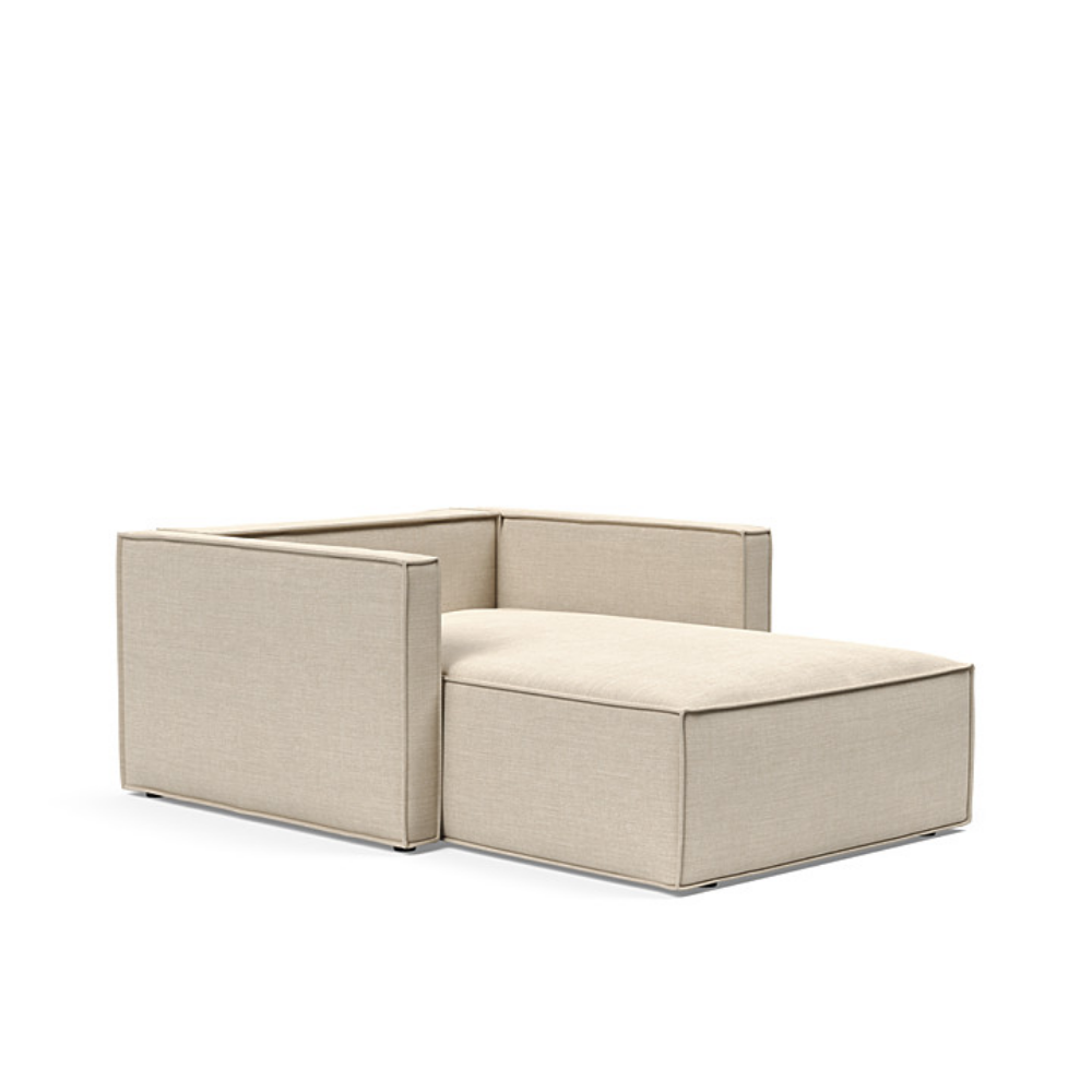 The Newilla Lounger Chair with Slim Arms with phobos latte 586 upholstery without the cushion, setup as a bed.