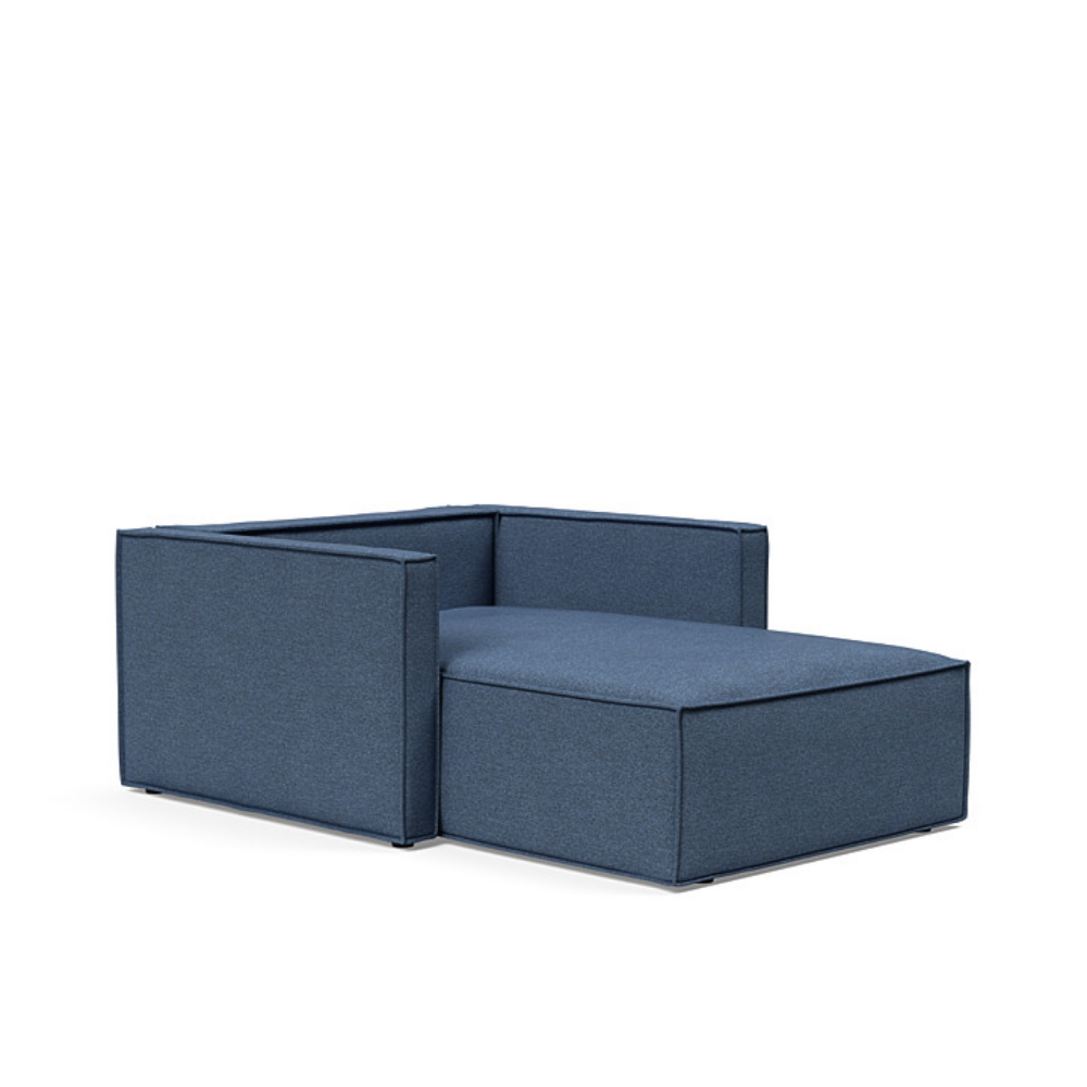The Newilla Lounger Chair with Slim Arms with weda blue 302 upholstery without the cushion, setup as a bed.