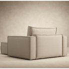 The Newilla Lounger Chair with Standard Arms from Innovation Living with adario taupe 257 upholstery from the back in a living area. all-groups