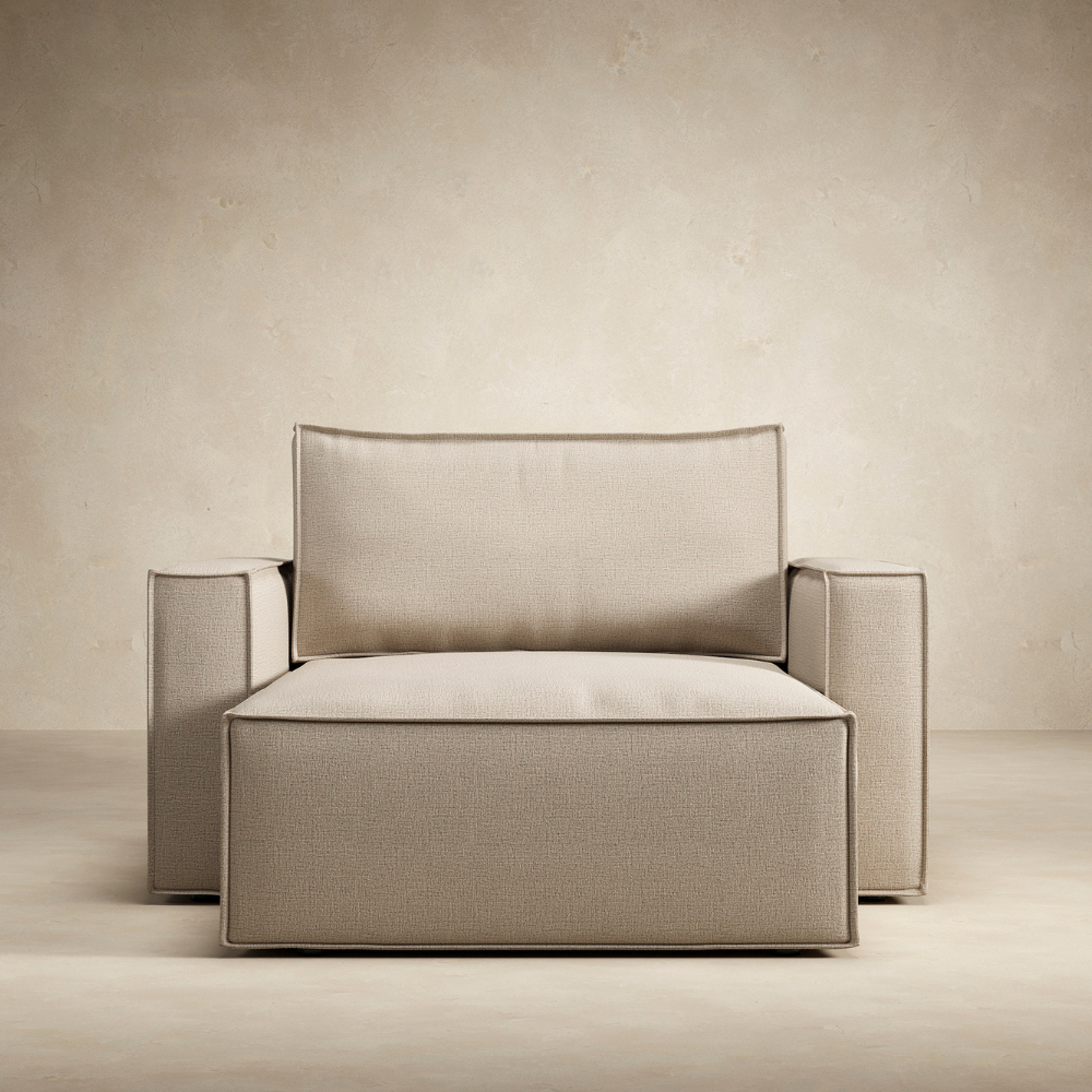 The Newilla Lounger Chair with Standard Arms from Innovation Living with adario taupe 257 upholstery from the front in a living room. all-groups