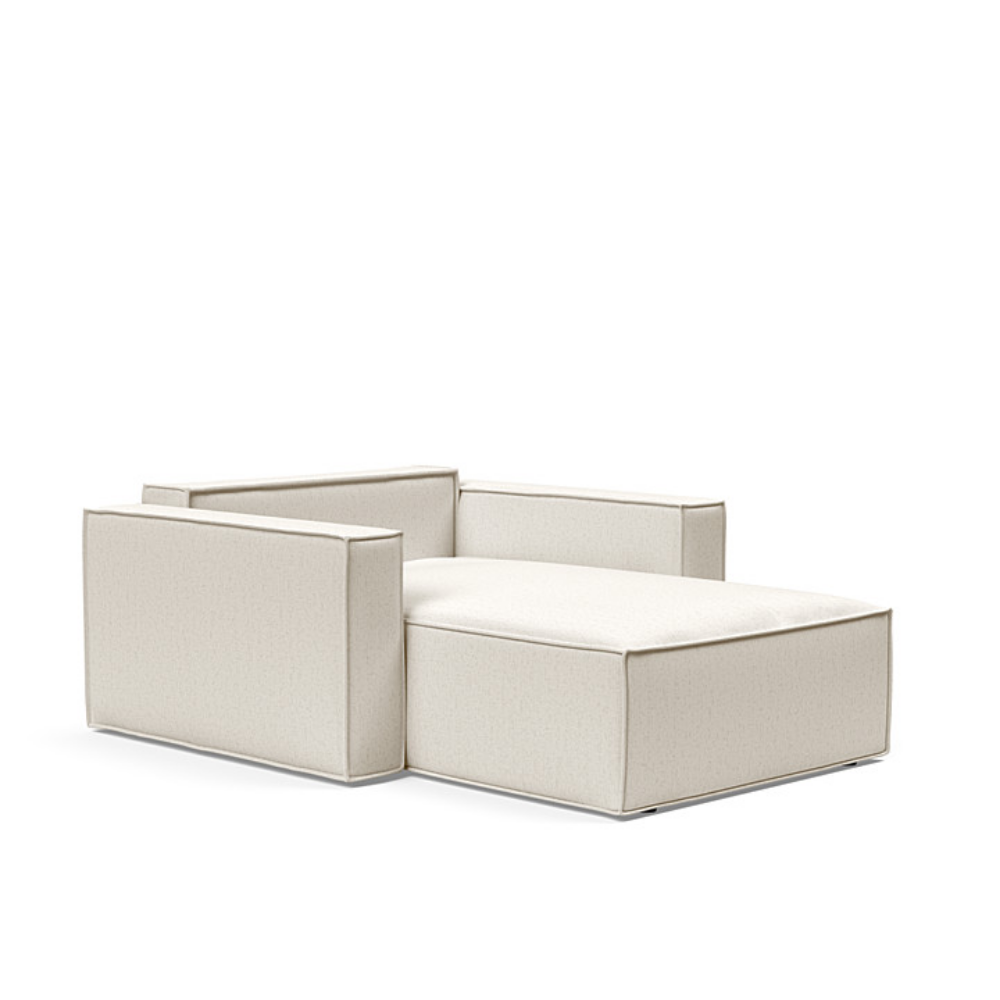The Newilla Lounger Chair with Standard Arms from Innovation Living with boucle off white 531 upholstery setup as a bed with the cushion removed.