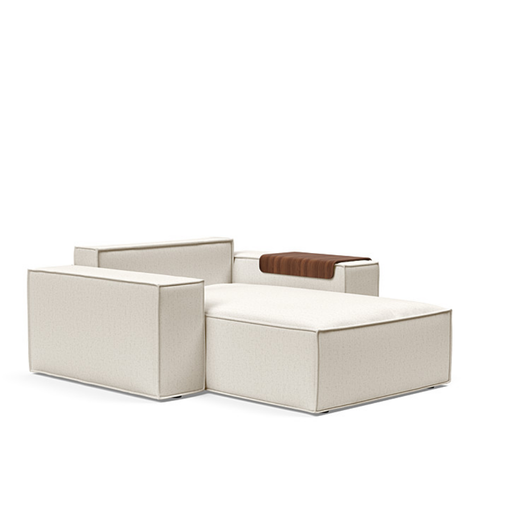 The Newilla Lounger Chair with Wide Arms from Innovation Living with boucle off white 531 upholstery without the cushion, setup as a bed.