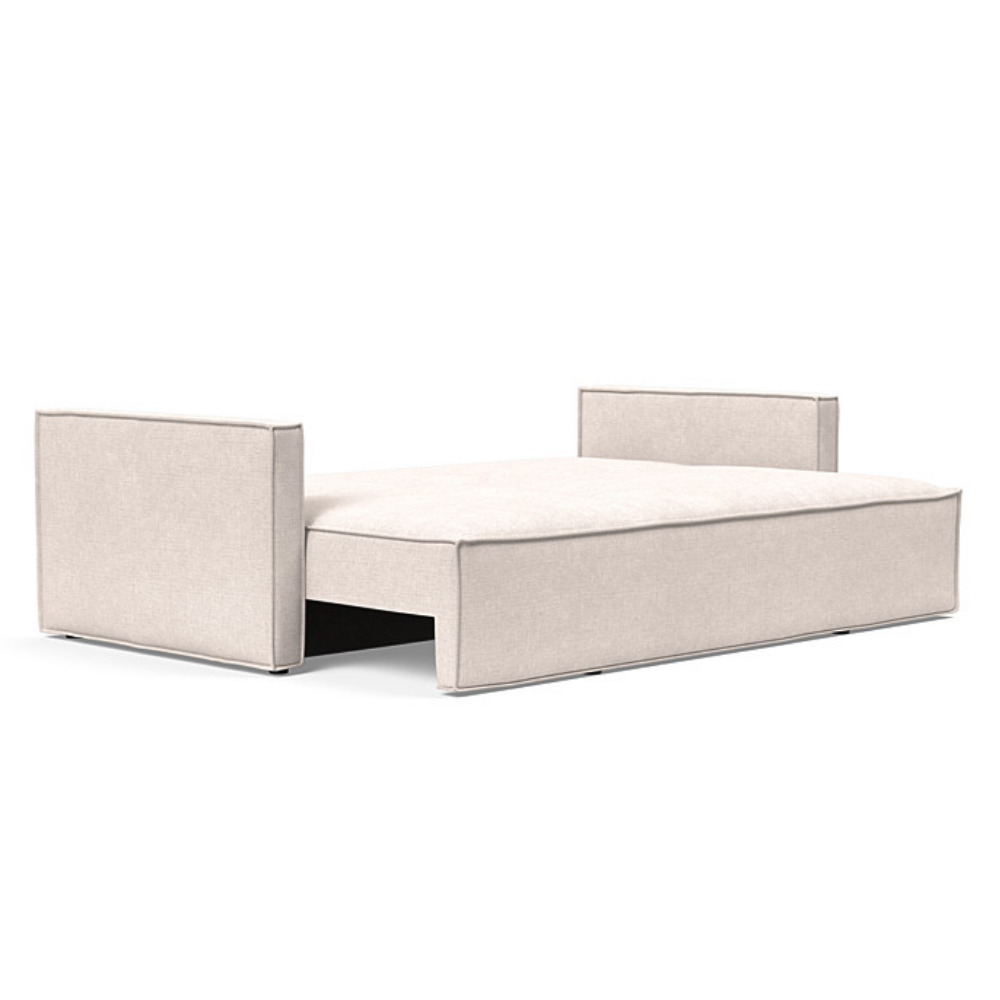The Newilla Sleeper Sofa from Innovation Living with slim arms and adario basmati 255 upholstery setup as a bed.
