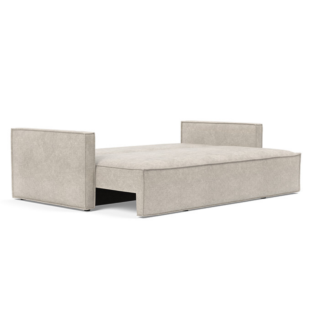 The Newilla Sleeper Sofa from Innovation Living with slim arms and avella sand 280 upholstery setup as a bed.