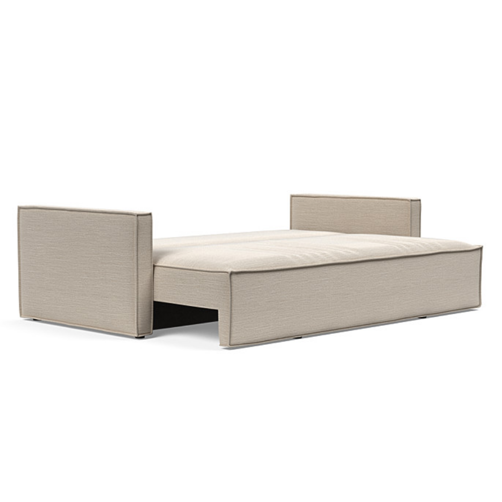 The Newilla Sleeper Sofa from Innovation Living with slim arms and blida sand grey 612 upholstery setup as a bed.