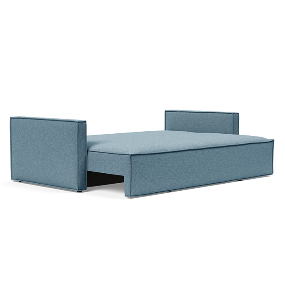 The Newilla Sleeper Sofa from Innovation Living with slim arms and mixed dance light blue 525 upholstery setup as a bed.
