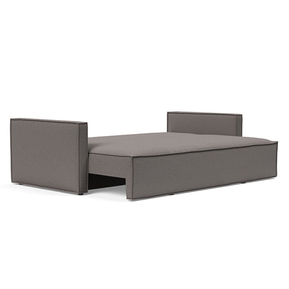 The Newilla Sleeper Sofa from Innovation Living with slim arms and mixed dance grey 521 upholstery setup as a bed.