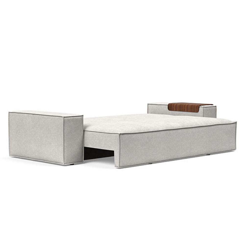 The Newilla Sleeper Sofa from Innovation Living with wide arms and adario fog 256 upholstery setup as a bed.