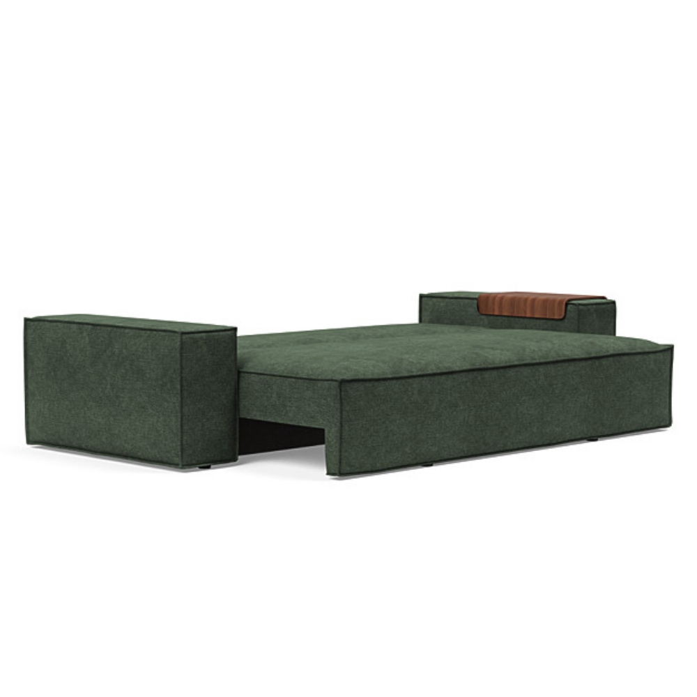 The Newilla Sleeper Sofa from Innovation Living with wide arms and avella pine green 281 upholstery setup as a bed.