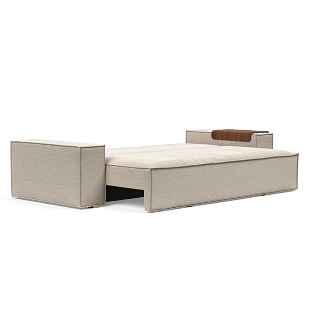 The Newilla Sleeper Sofa from Innovation Living with wide arms and blida sand grey 612 upholstery setup as a bed.