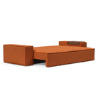 The Newilla Sleeper Sofa from Innovation Living with wide arms and esina rust orange 412 upholstery setup as a bed.