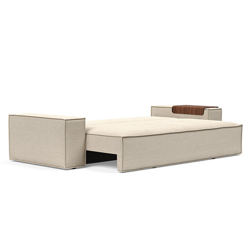 The Newilla Sleeper Sofa from Innovation Living with wide arms and phobos latte 586 upholstery setup as a bed.