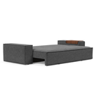 The Newilla Sleeper Sofa from Innovation Living with wide arms and taura deep grey 350 upholstery setup as a bed.