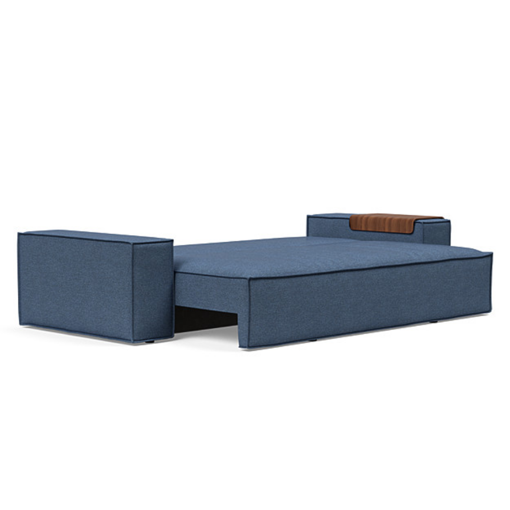 The Newilla Sleeper Sofa from Innovation Living with wide arms and weda blue 302 upholstery setup as a bed.