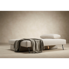 The Osvald Sofa Bed from Innovation Living with phobos latte 586 upholstery setup as a bed in a living space.