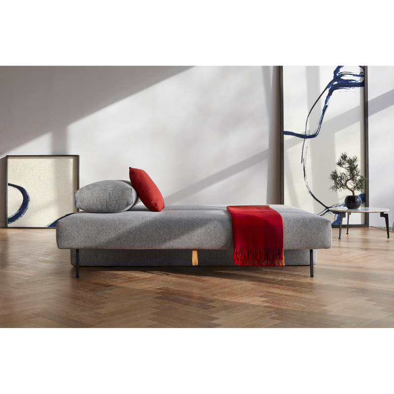 The Osvald Sofa Bed from Innovation Living with twist granite 565 upholstery within a designer home's lounge.