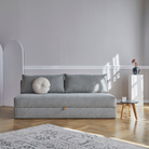 The Osvald Sofa Bed from Innovation Living with twist granite 565 upholstery in a lounge.