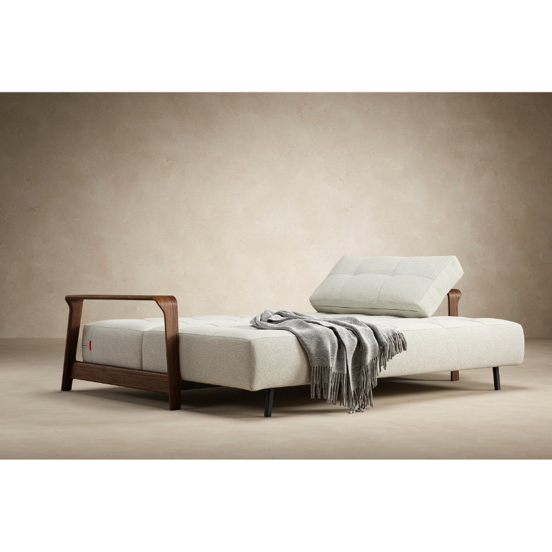 The Ran D.E.L Sofa Bed from Innovation Living with mixed dance natural 527 upholstery in a designer home setup as a bed.