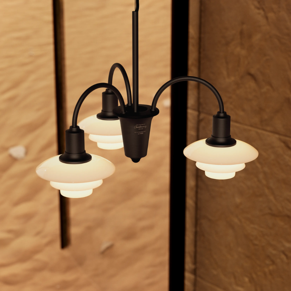 Campaign photo of the PH 1/1 Chandelier, 3-Light by Louis Poulsen turned on.